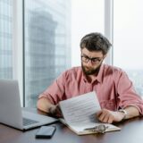 A person reviewing health savings documents related to HSA eligibility expansion 2025.