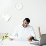 Person organizing tax documents at a desk