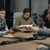 Family sitting around a table discussing financial gifts and money matters together