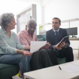 Senior couple reviewing Health Savings Account statements and retirement planning documents