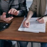 Person calculating mileage deductions for tax planning
