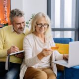 Affluent retired couple reviewing Social Security benefits and financial plans together