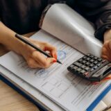 Calculator and tax documents representing 2026 tax deductions and refund planning