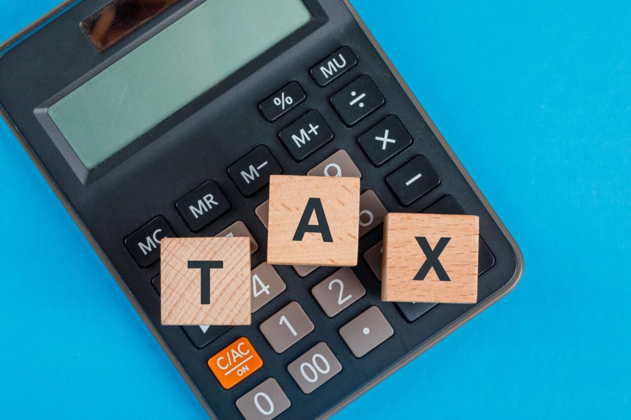 tax-planning-concept-with-wooden-cubes-calculator-blue-table-flat-lay-1280x853.jpg