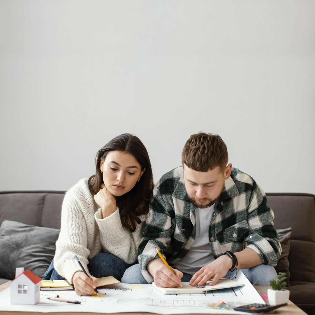 medium-shot-couple-drawing-plans_optimized_1000-1280x1280.jpg